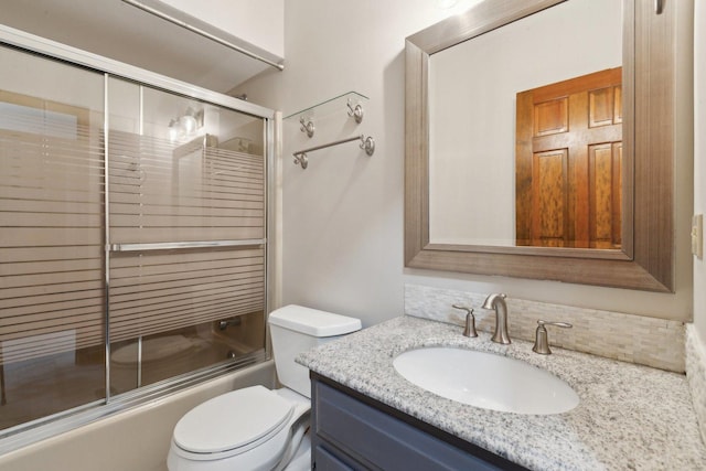 full bathroom with shower / bath combination with glass door, vanity, and toilet