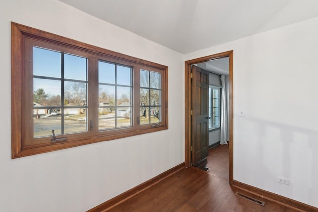 spare room featuring dark hardwood / wood-style floors