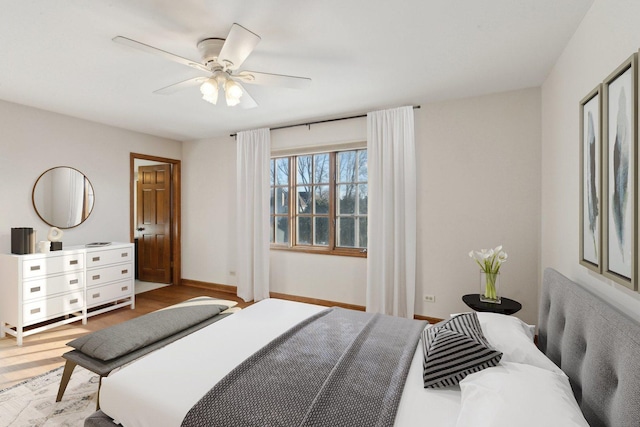 bedroom with light hardwood / wood-style floors and ceiling fan