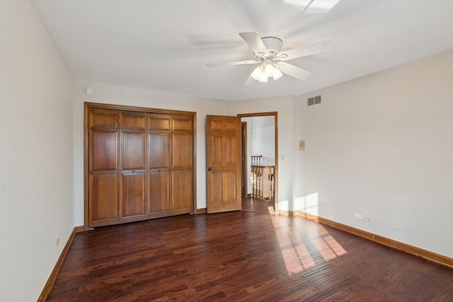 unfurnished bedroom with dark wood-type flooring and ceiling fan