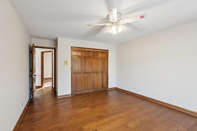 unfurnished bedroom featuring a closet, ceiling fan, and dark hardwood / wood-style flooring