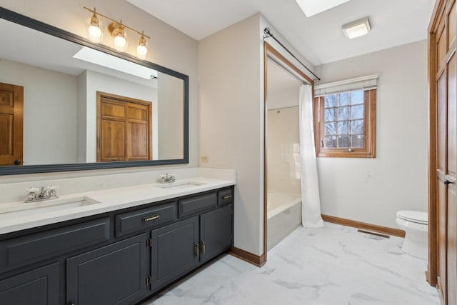 full bathroom with toilet, vanity, a skylight, and shower / tub combo