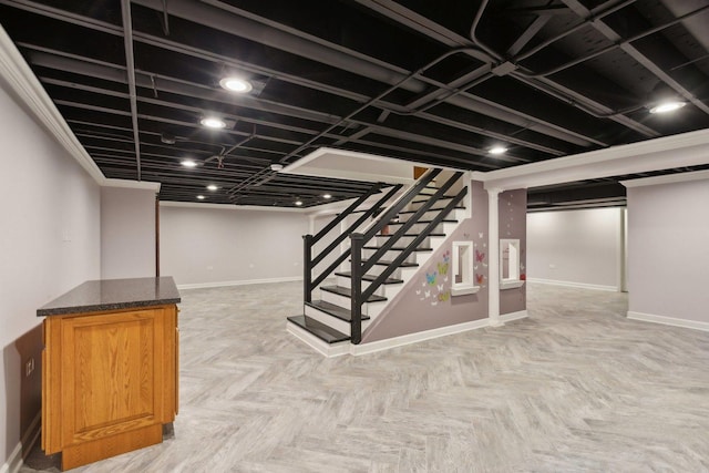 basement featuring light parquet floors and ornamental molding