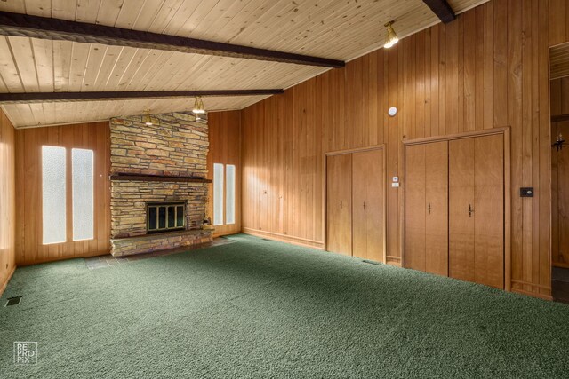 unfurnished living room featuring a fireplace, vaulted ceiling with beams, wooden walls, carpet flooring, and wood ceiling