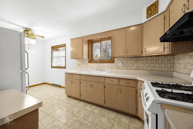 kitchen with light tile patterned floors, sink, and light brown cabinets