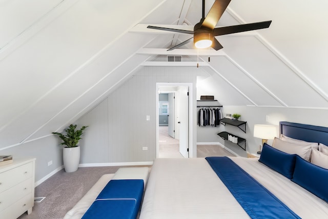 bedroom featuring ceiling fan, light colored carpet, and vaulted ceiling