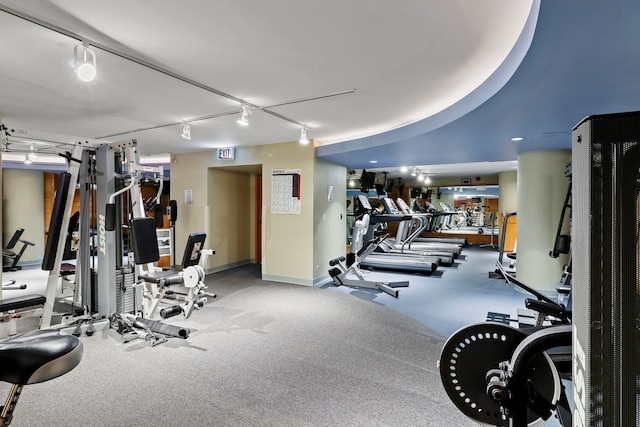 exercise room featuring track lighting