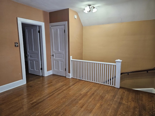 bonus room featuring hardwood / wood-style flooring and vaulted ceiling