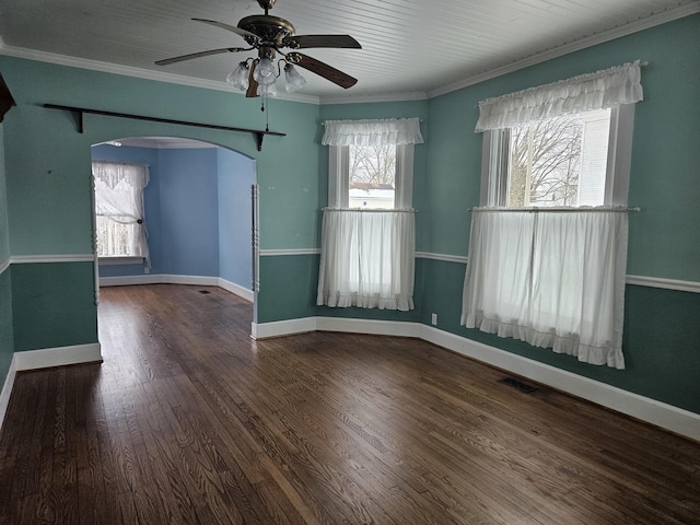 unfurnished room featuring ceiling fan, crown molding, and dark hardwood / wood-style floors