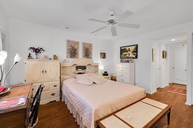 bedroom with dark hardwood / wood-style flooring and ceiling fan