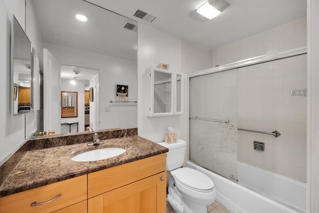 full bathroom with toilet, vanity, tile patterned flooring, and combined bath / shower with glass door