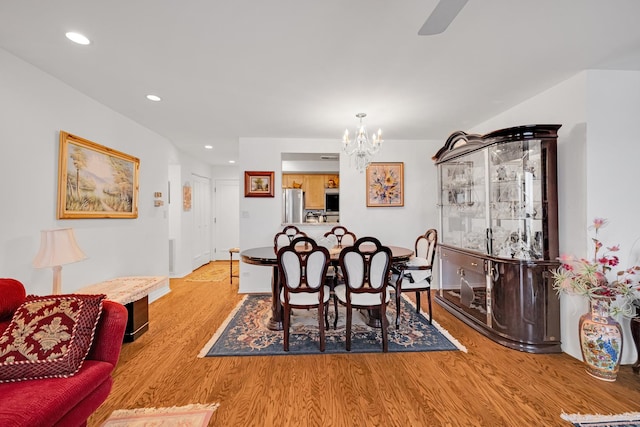 dining room with a chandelier and light hardwood / wood-style floors