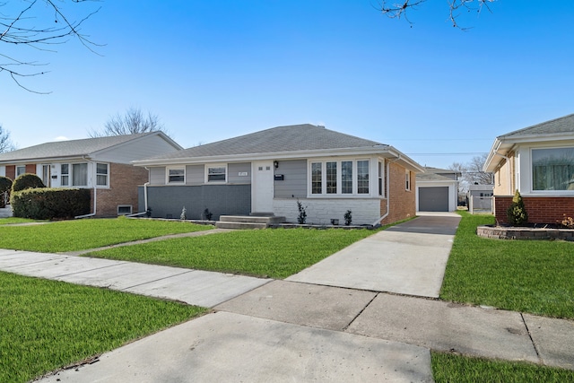 view of front of home with a garage, a front lawn, and an outdoor structure