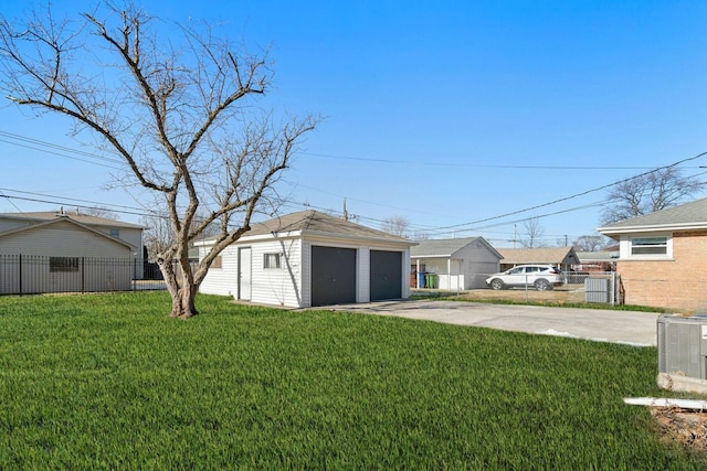 view of yard featuring a garage, an outbuilding, and central air condition unit