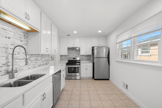 kitchen with decorative backsplash, sink, light tile patterned flooring, appliances with stainless steel finishes, and white cabinets