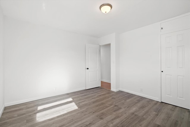 spare room featuring wood-type flooring