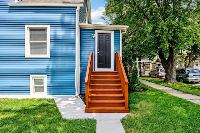 doorway to property with a yard