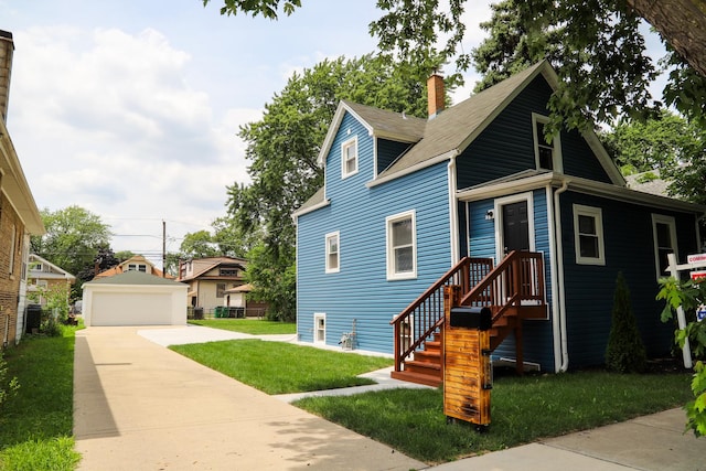 view of front of home featuring an outbuilding, a front lawn, and a garage