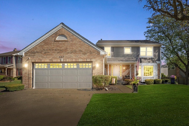 front facade with a yard and a garage