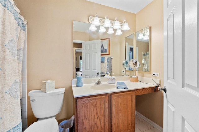 bathroom with toilet, vanity, and tile patterned floors