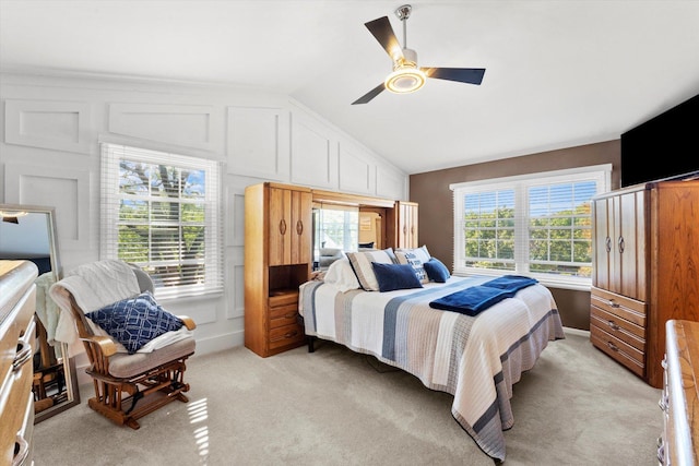 carpeted bedroom with vaulted ceiling and ceiling fan