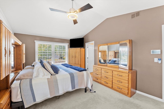 bedroom with light colored carpet, ceiling fan, and lofted ceiling