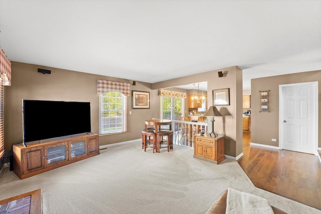 living room featuring a chandelier and light colored carpet