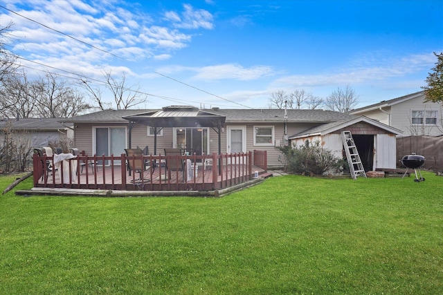 back of house featuring a gazebo, a wooden deck, a yard, and a storage shed