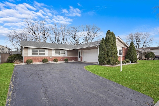 ranch-style home with a garage and a front lawn