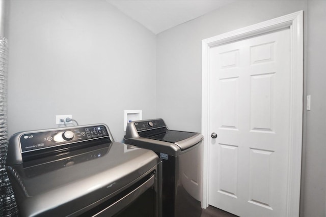 washroom featuring separate washer and dryer and dark hardwood / wood-style floors