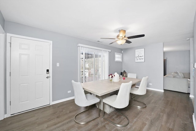 dining room with ceiling fan and dark hardwood / wood-style floors