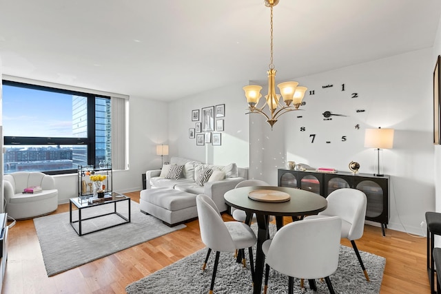 dining room with hardwood / wood-style flooring and a notable chandelier