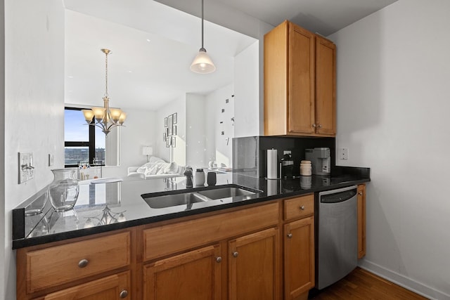 kitchen featuring decorative light fixtures, sink, dark stone countertops, dark hardwood / wood-style flooring, and stainless steel dishwasher