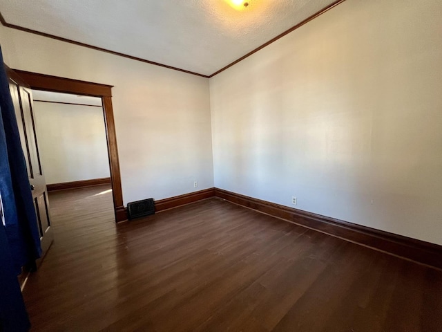 298 N Adams St, El Paso, IL 61738 - empty room with a textured ceiling, lofted ceiling, dark hardwood / wood-style flooring, and crown molding