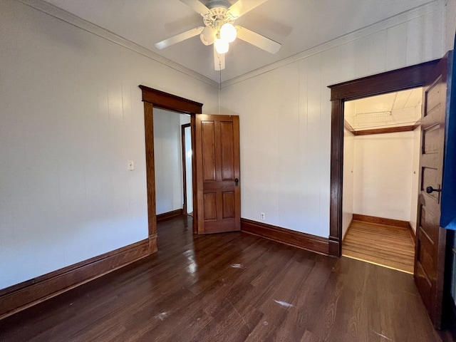 298 N Adams St, El Paso, IL 61738 - unfurnished bedroom featuring crown molding, dark wood-type flooring, a closet, and ceiling fan