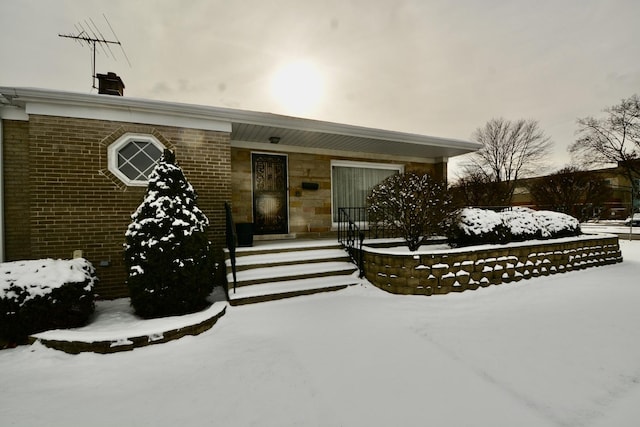 view of snow covered property entrance