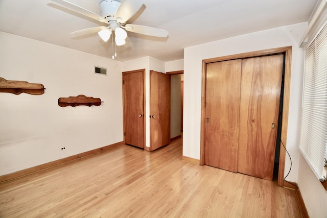 unfurnished bedroom featuring ceiling fan, a closet, and light hardwood / wood-style flooring