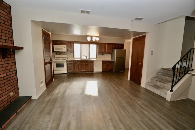 unfurnished living room featuring dark hardwood / wood-style flooring and sink