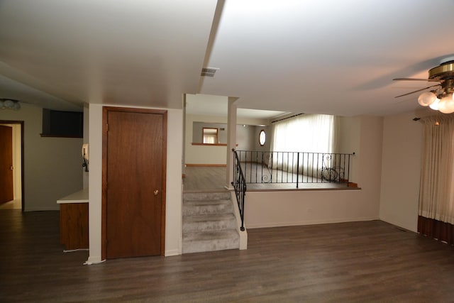 unfurnished living room featuring dark hardwood / wood-style floors and ceiling fan