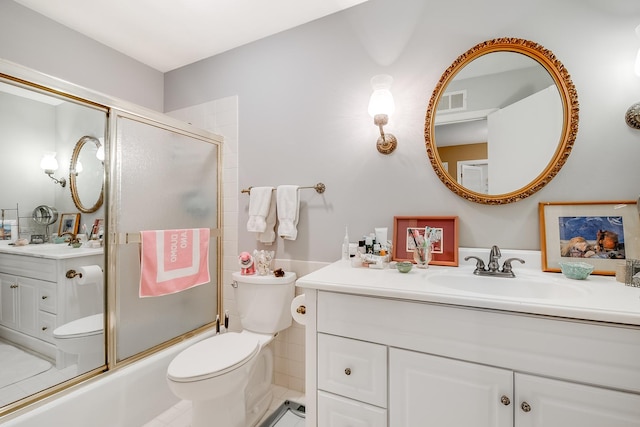 full bathroom featuring toilet, vanity, and shower / bath combination with glass door