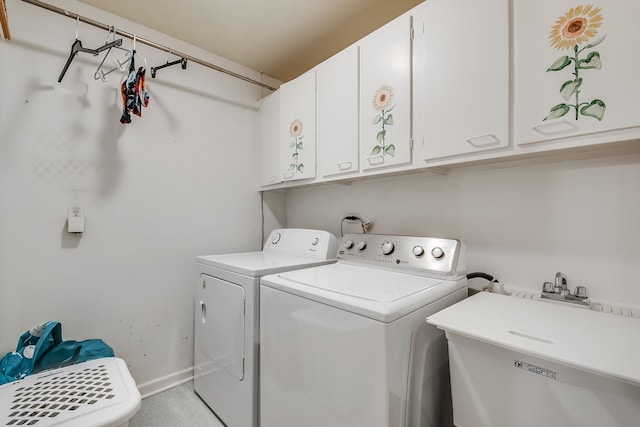 laundry room with independent washer and dryer, sink, and cabinets