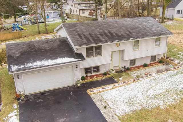 view of front of property featuring a garage and a playground