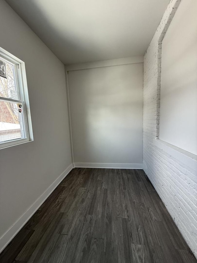 empty room with dark hardwood / wood-style flooring