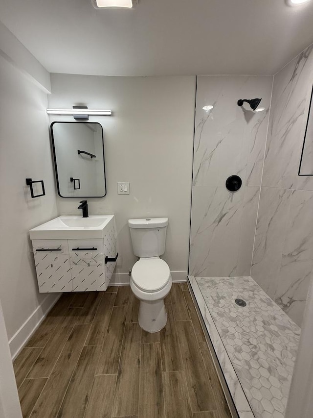 bathroom featuring vanity, toilet, and walk in shower