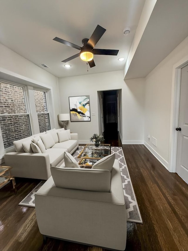 living room with dark hardwood / wood-style floors and ceiling fan