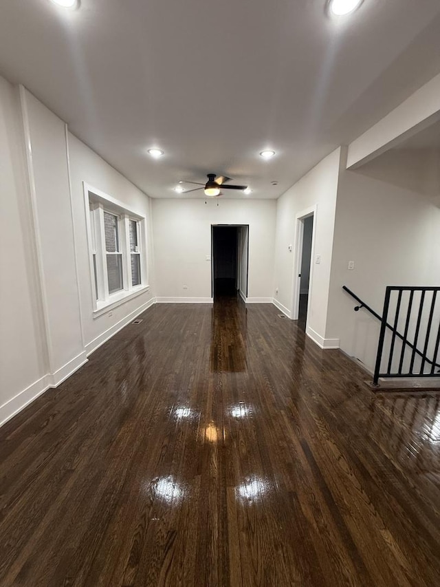 unfurnished living room with ceiling fan and dark hardwood / wood-style flooring