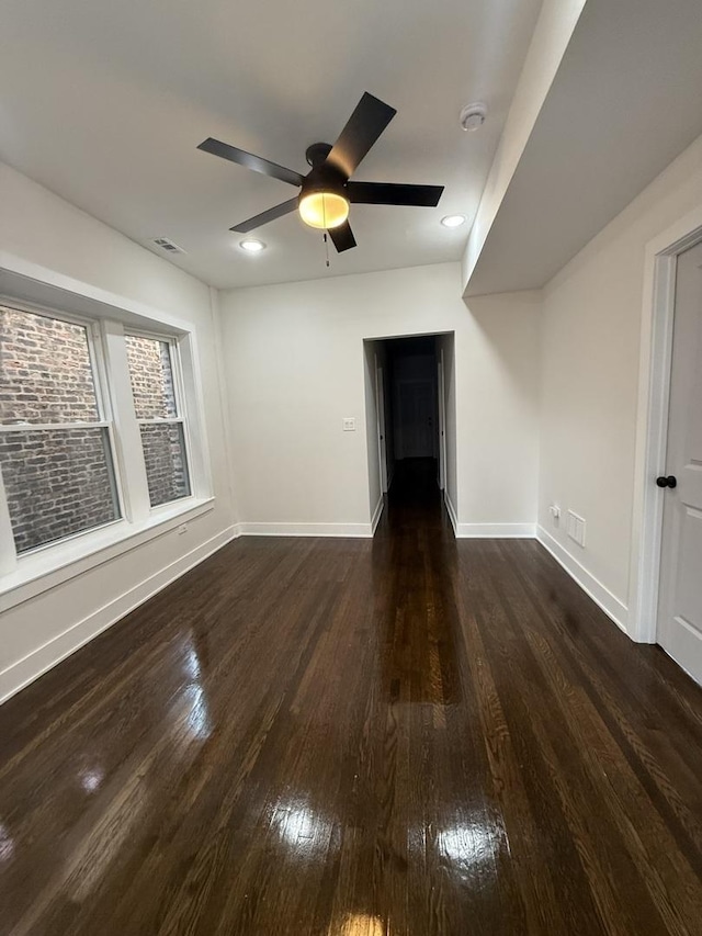 interior space with ceiling fan and dark hardwood / wood-style flooring