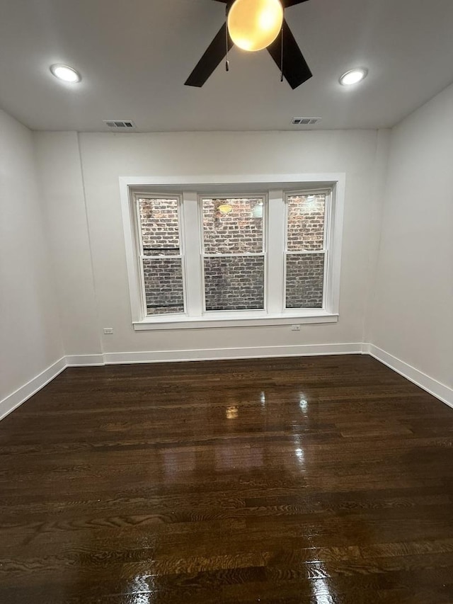 unfurnished room featuring dark hardwood / wood-style flooring and ceiling fan