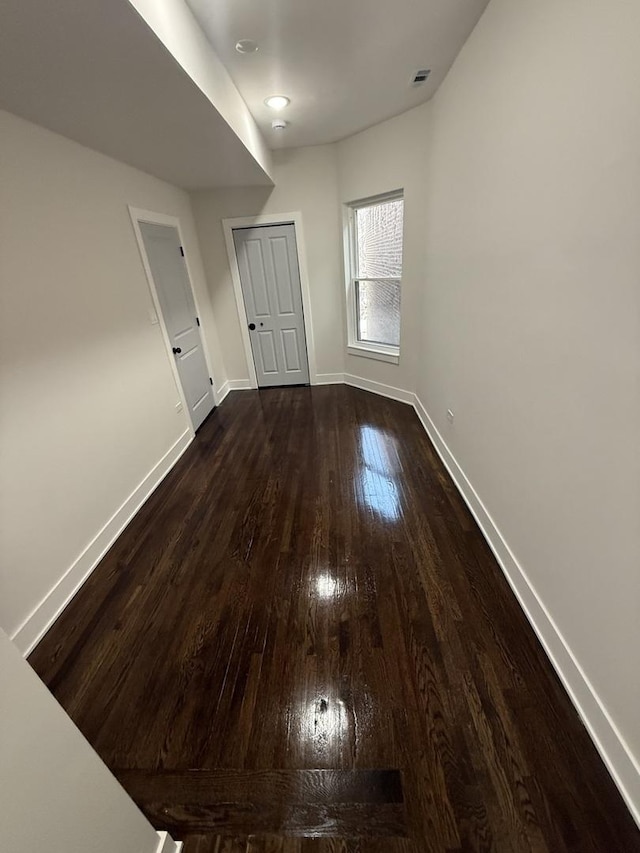 spare room featuring dark wood-type flooring