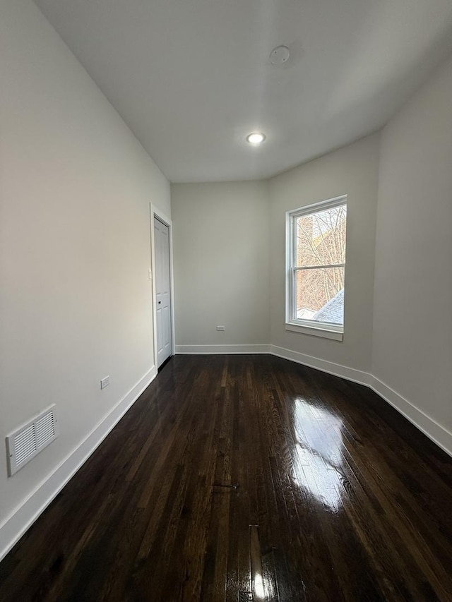 spare room with dark hardwood / wood-style flooring